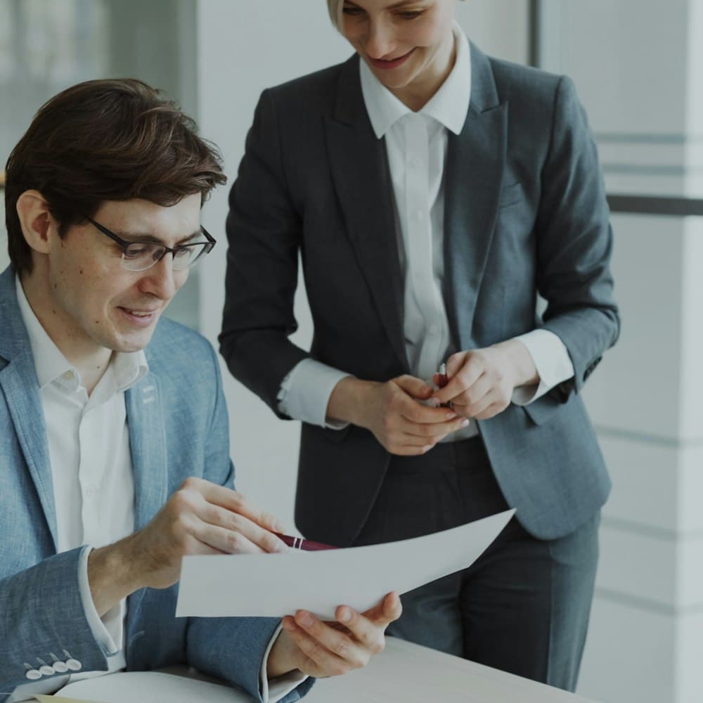 Two colleagues reviewing a document together